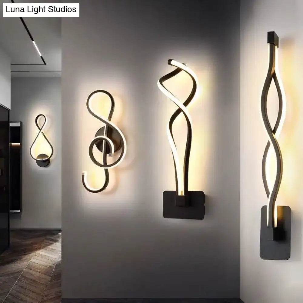 Minimalist line art sconce light fixture featuring sleek twisted black metal design with warm white LED light for hallways