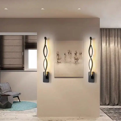 Minimalist line art sconce light fixture in black metal with sleek twisted design emitting a warm glow for hallways