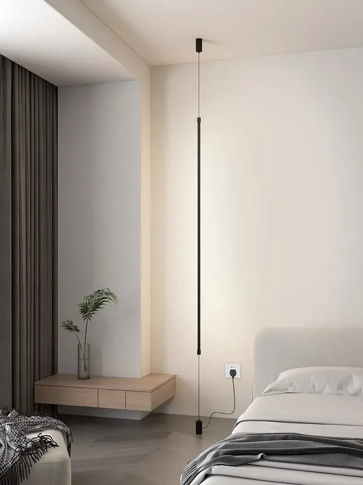Minimalist matte black bedside pendant light with straight strip design and slender cylindrical shape for bedroom use