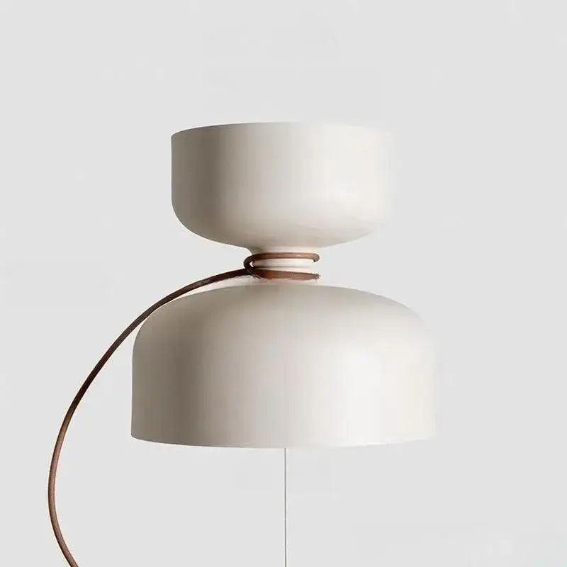 Cream-colored ceramic pendant light with curved brown leather strap and off-white forged iron chandelier design by decorbites