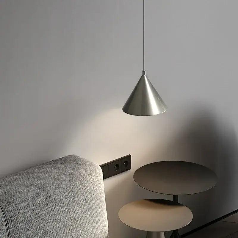 A sleek minimalist matte black metallic pendant light chandelier with a cone shape hanging for dining room use