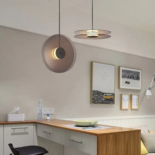 Modern minimalist glass pendant light with matte metal shade and warm led illumination for dining room