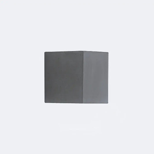 A minimalist matte gray concrete wall sconce with a square shape designed as a corridor led light block