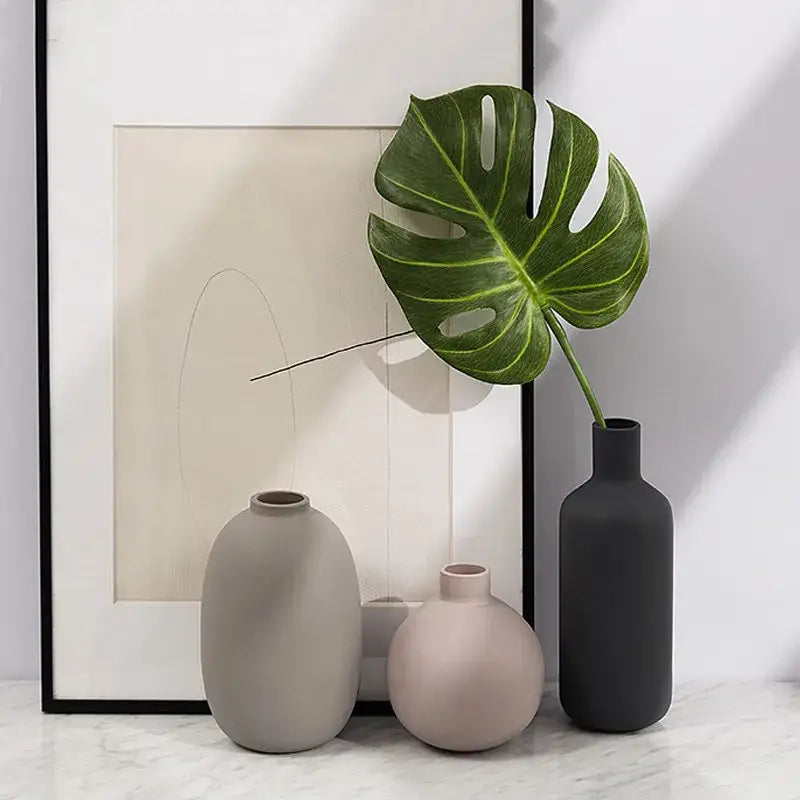Three minimalist geometric ceramic vases in muted gray blush pink and dark charcoal with matte finish for decorbites decor