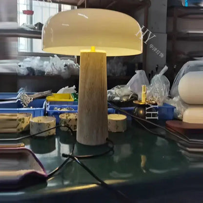 Cream-colored minimalist mushroom cave stone table lamp with frosted glass and textured wooden base for bedroom decorbites cave stone table