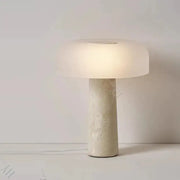 Minimalist mushroom-shaped table lamp with frosted glass shade and textured decorbites cave stone table base for bedroom