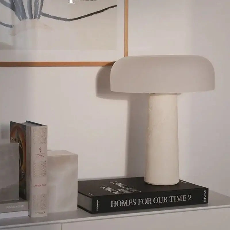 Cream-colored minimalist mushroom glass and decorbites cream marble table lamp with matte finish and cylindrical base for bedroom