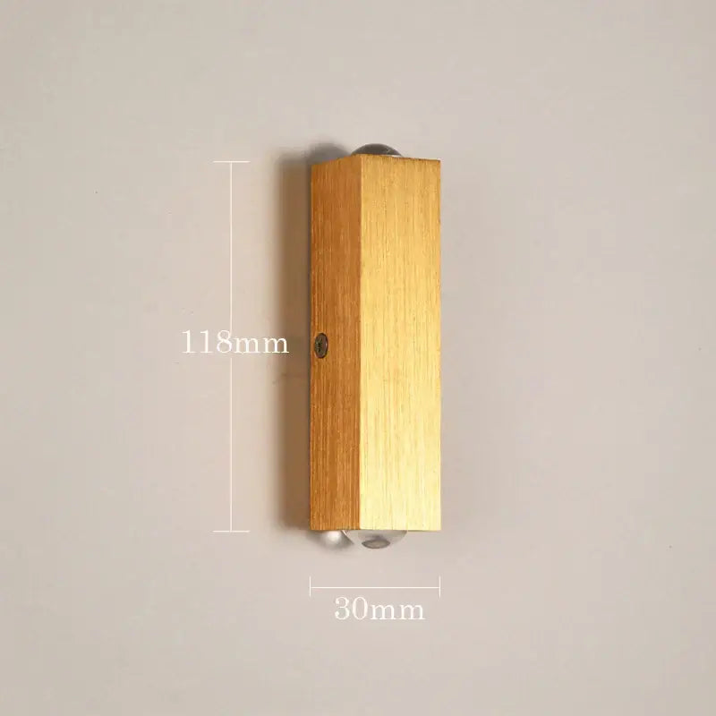 Minimalist natural wood angled wall lamp with decorbites brushed gold finish and subtle wood grain texture for bedroom decor