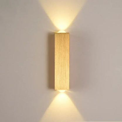 Minimalist natural wood angled wall lamp with decorbites brushed gold finish and vertical wood grain texture for bedroom decor