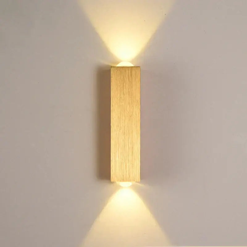 Minimalist natural wood angled wall lamp with decorbites brushed gold finish and vertical wood grain texture for bedroom decor