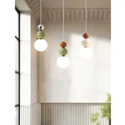 Minimalist nordic pendant light with tiered glossy spheres in terracotta sage and white for bedroom decorbites cream style