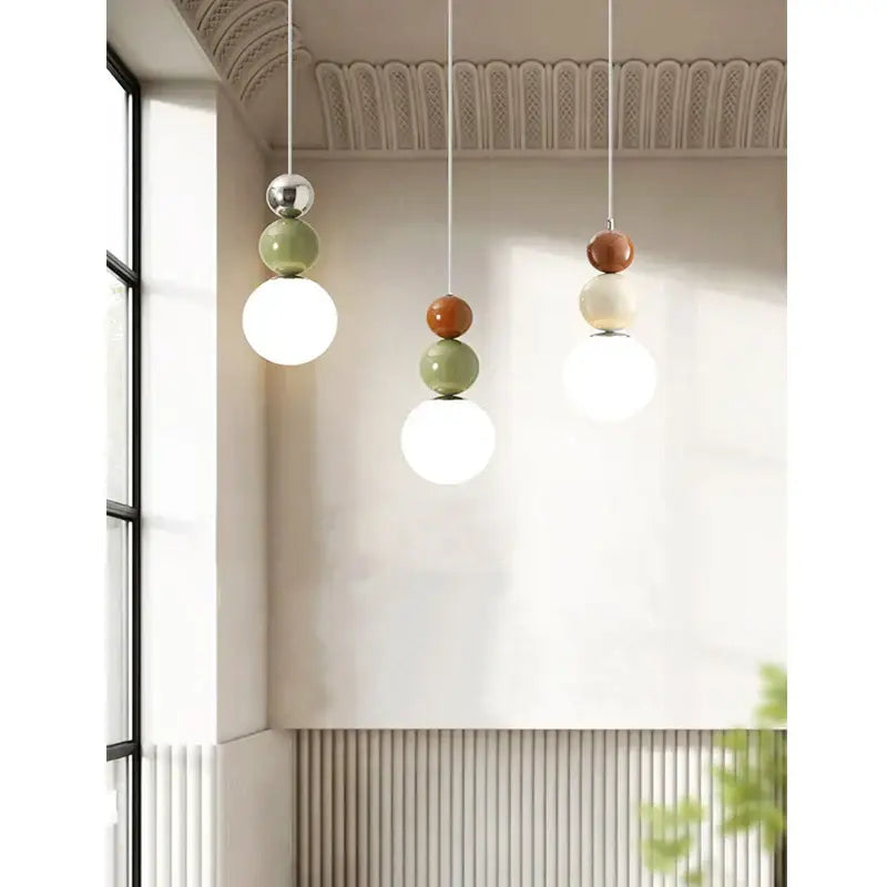 Minimalist nordic pendant light with tiered glossy spheres in terracotta sage and white for bedroom decorbites cream style