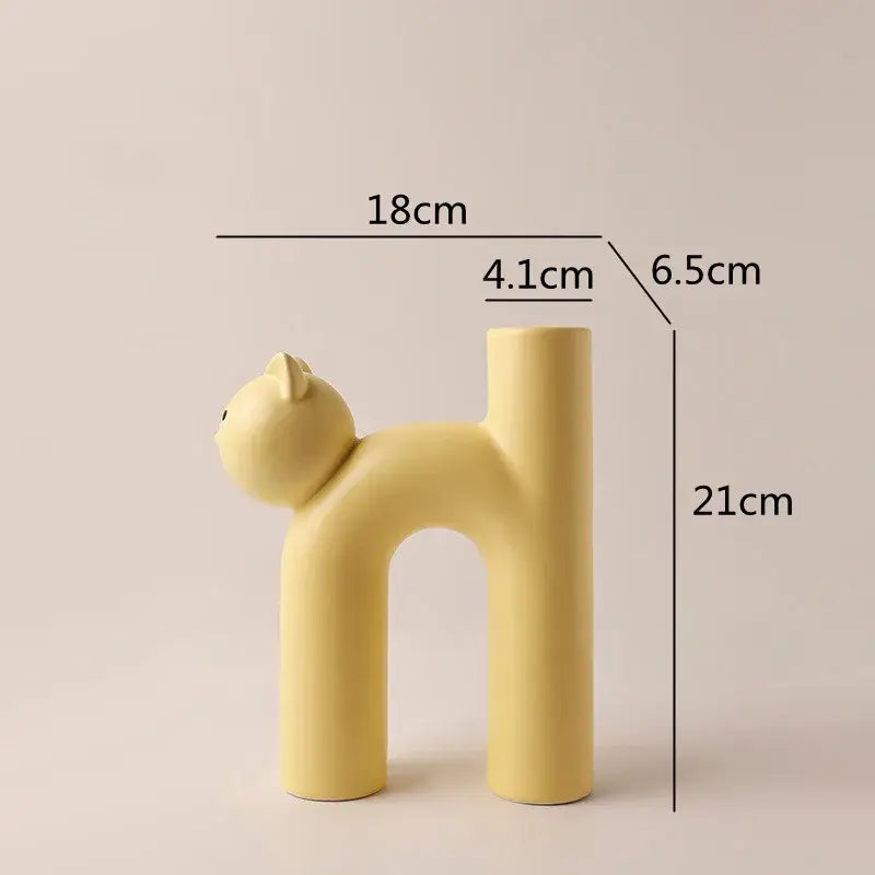 Minimalist pastel yellow ceramic decorbites cathead tube vase with smooth rounded features for living room decor