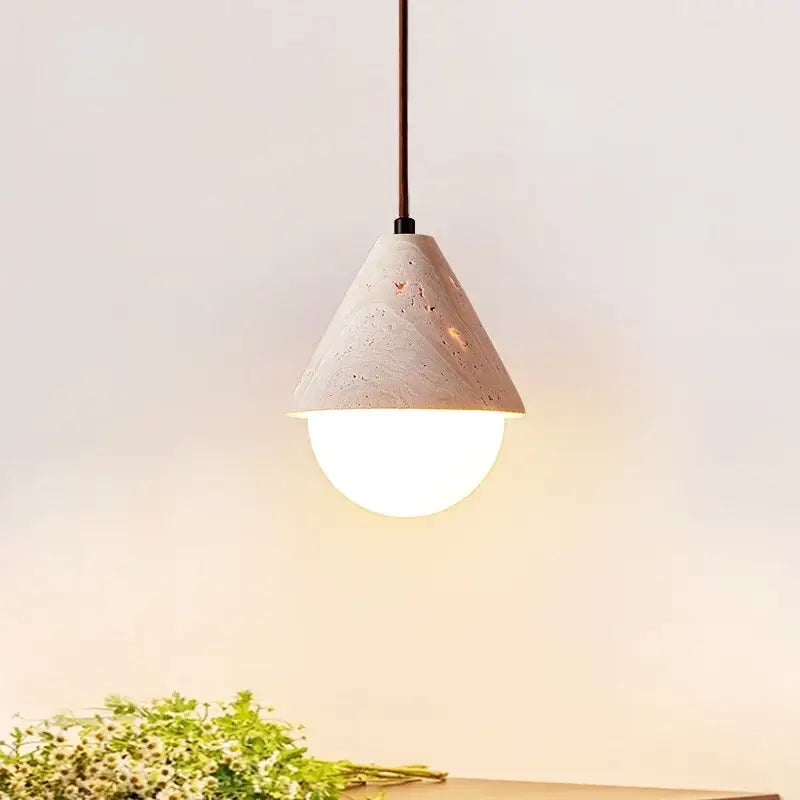 Minimalist off white concrete pendant light with textured conical shade and warm glow by decorbites creative stone led