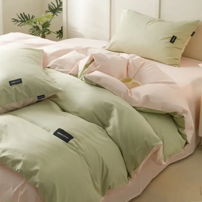 Pastel green and pink color matching cotton bedding set with subtle black brand tags for minimalist bedroom use