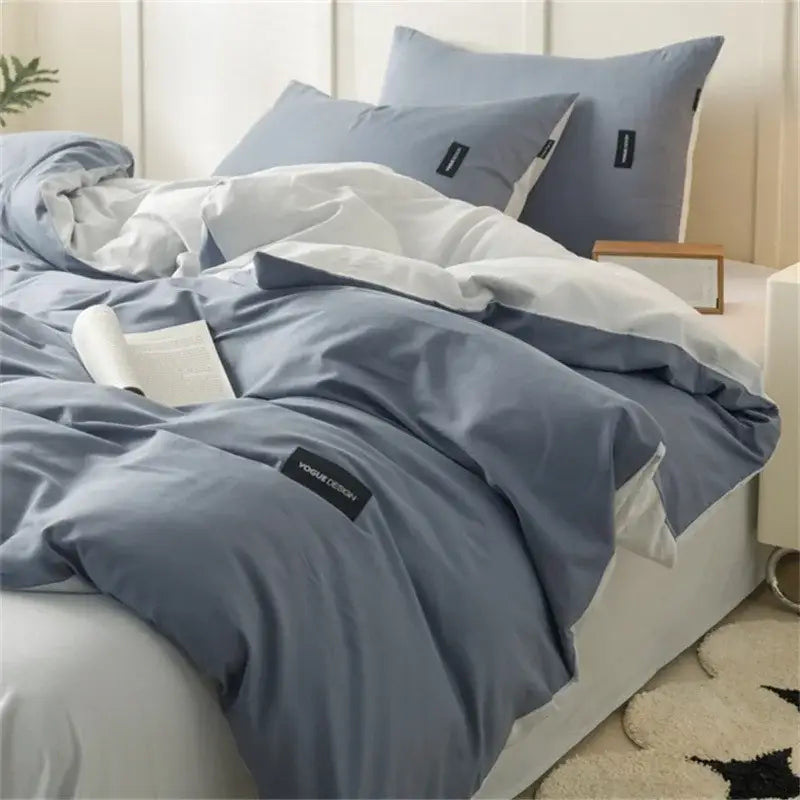 Blue and white color matching cotton bedding set with soft textured fabric and black rectangular brand tags
