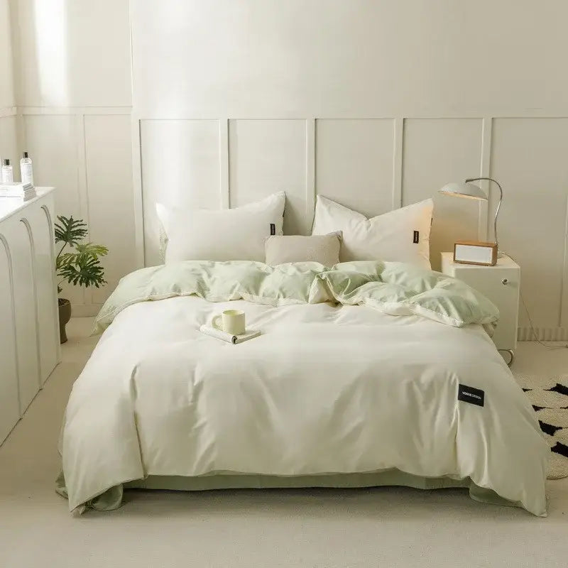 Soft mint green satin duvet cover set with matching cotton pillowcases and subtle brand tag in minimalist bedroom