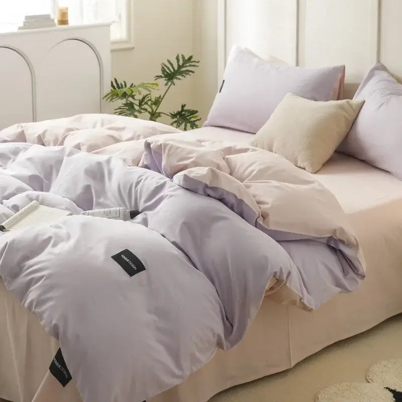 Soft lavender-colored duvet cover with subtle sheen and stitched edges in minimalist off-white and mint matching cotton bedding set