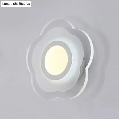A modern off white cloud-shaped wall lamp with a soft glowing center featuring triangle round square design elements