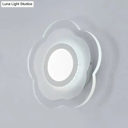 A minimalist off white wall lamp with a triangle round square design and a frosted glass cloud-shaped diffuser