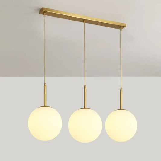 Minimalist Opal Glass Sphere Pendant Light with 3-Bulb Gold Pendulum Design - Ideal for Dining Room