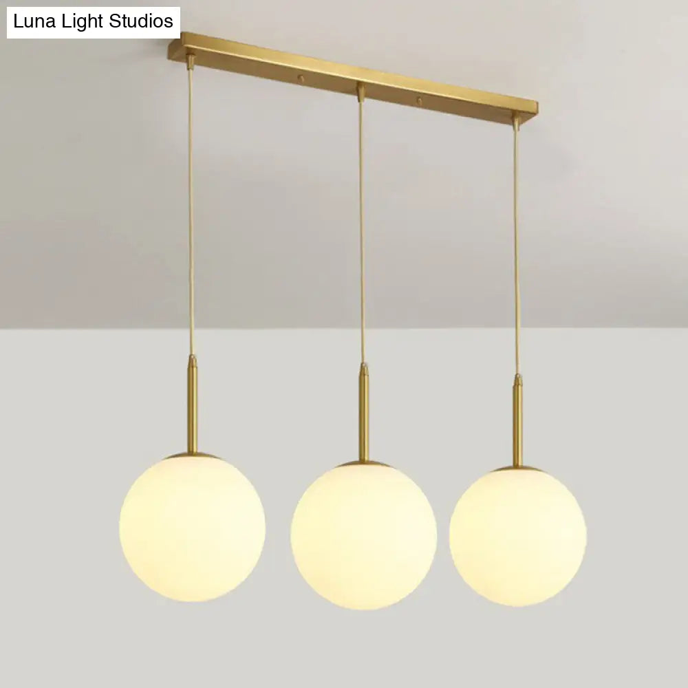 Minimalist Opal Glass Sphere Pendant Light with 3-Bulb Gold Pendulum Design - Ideal for Dining Room