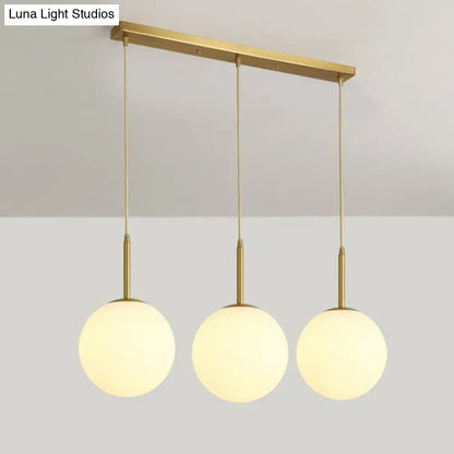 Minimalist Opal Glass Sphere Pendant Light with 3-Bulb Gold Pendulum Design - Ideal for Dining Room