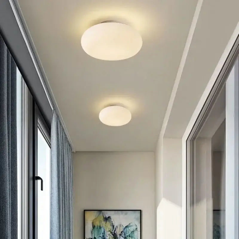 Two minimalist oval white frosted glass pendant lamps from decorbites big ball pendant emit soft white light