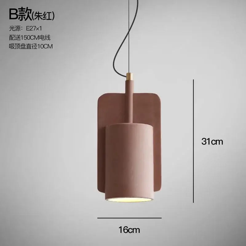 Minimalist pastel cement pendant lamp with a matte dusty rose cylinder shade and black cord by decorbites cement pendant