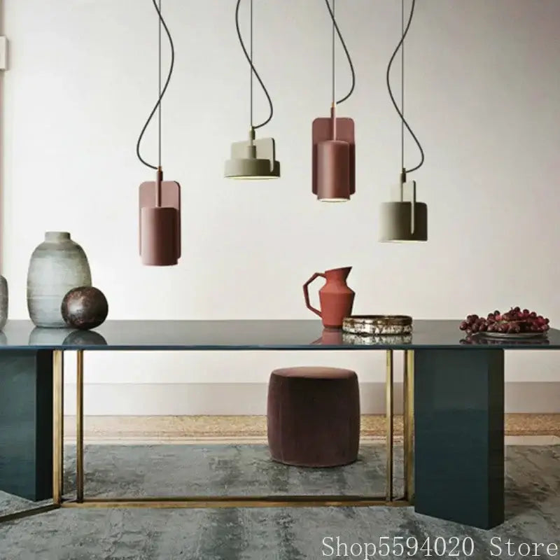 Minimalist pastel cement pendant lamp with sleek black cords and terracotta and sage green cylindrical shades decorbites cement pendant
