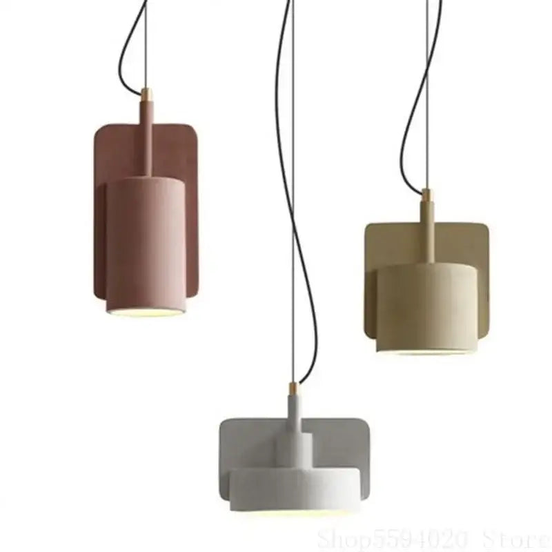 Three modern decorbites cement pendant lamps with cylindrical shades in pastel pink beige and gray for kitchen decor