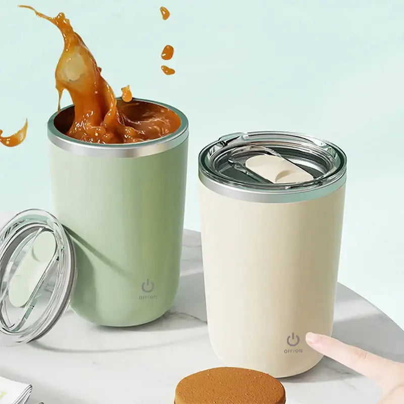 Two pastel electric magnetic stirring coffee cups in mint green and cream with silver rimmed lids and on off buttons