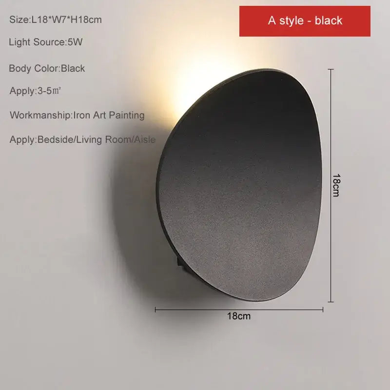 Minimalist black matte led wall lamp with sleek oval design for bedroom accent lighting