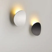 Minimalist silver and black led wall lamp with sleek oval designs in polished silver and matte black finishes for bedroom