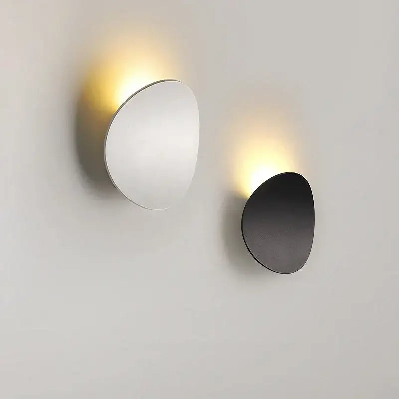 Minimalist silver and black led wall lamp with sleek oval designs in polished silver and matte black finishes for bedroom