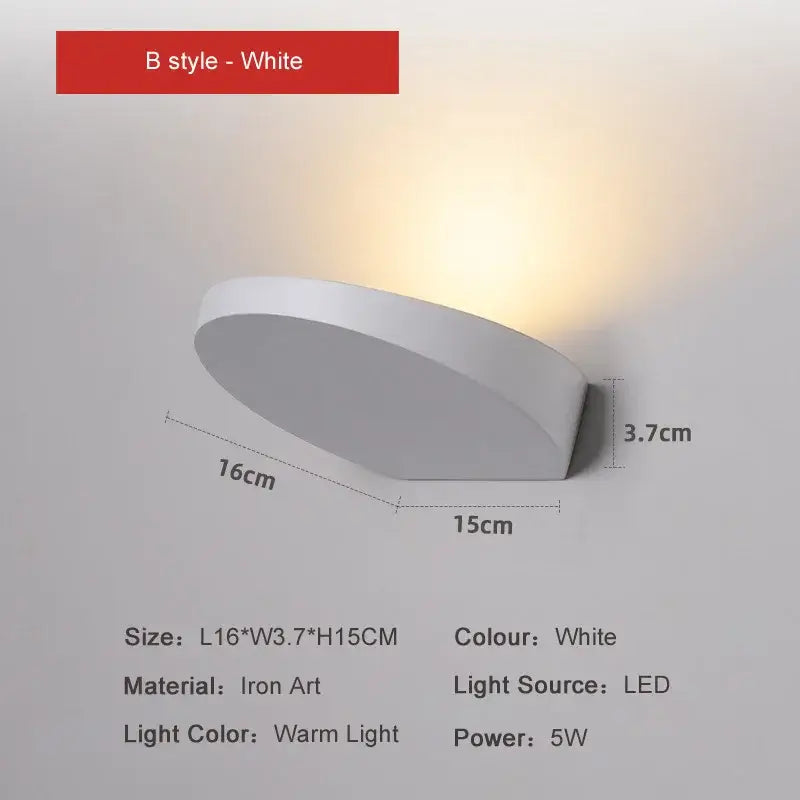 Minimalist silver and black led wall lamp with sleek curved design and warm light output for bedroom use