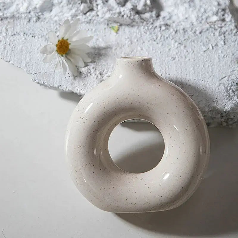 Cream-colored ceramic donut candle holder with subtle speckles minimalist speckled off-white decorbites ceramic donut