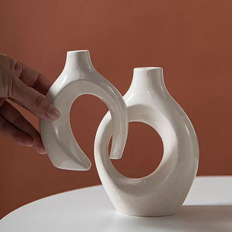 Minimalist off-white ceramic donut candle holder with speckled finish and abstract circular decorbites ceramic donut design