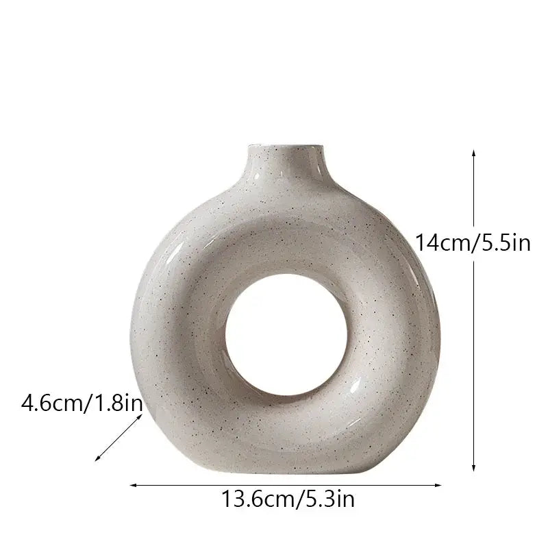 Minimalist off-white ceramic donut candle holder with speckled finish by decorbites for elegant dining room decorbites ceramic donut