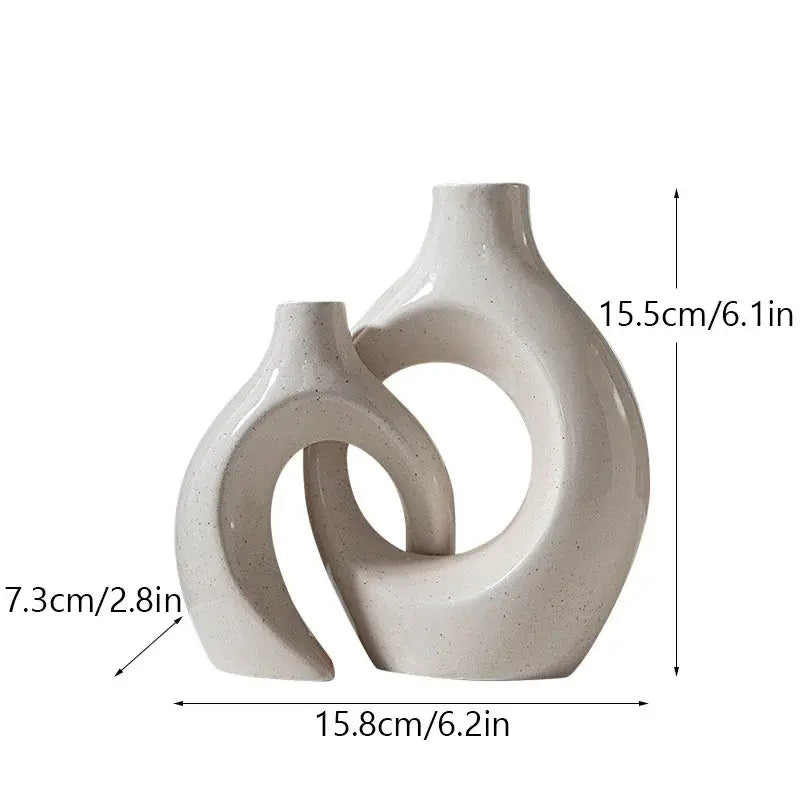 Cream-colored decorbites ceramic donut candle holder with modern abstract curves and subtle speckles for minimalist dining room decor