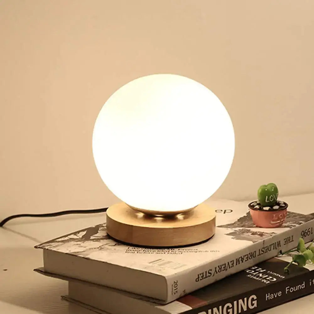 Minimalist warm white glass ball table lamp with spherical glass and wooden base perfect for bedroom decorbites glass ball