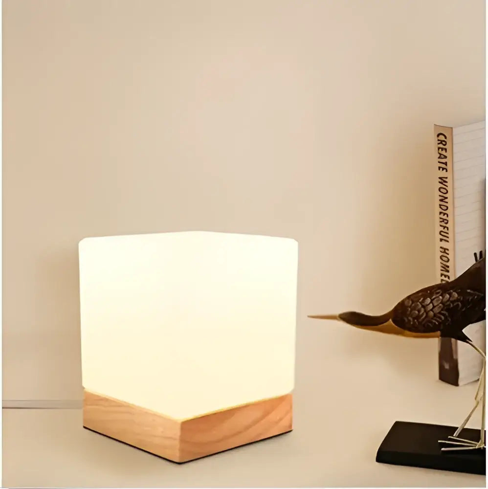 Minimalist white cube-shaped led table lamp with natural wood base from decorbites glass ball table collection