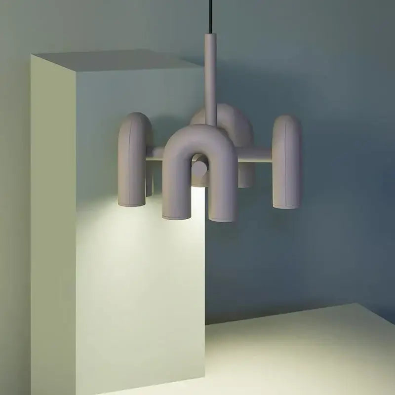 Pastel lavender modernist cirkus tube wall sconce with matte ceramic arms in geometric design for bedroom reading light