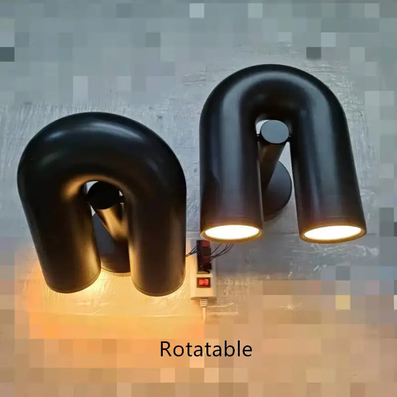Black minimalist cirkus tube wall sconces with matte finish and warm led lighting for bedroom reading light