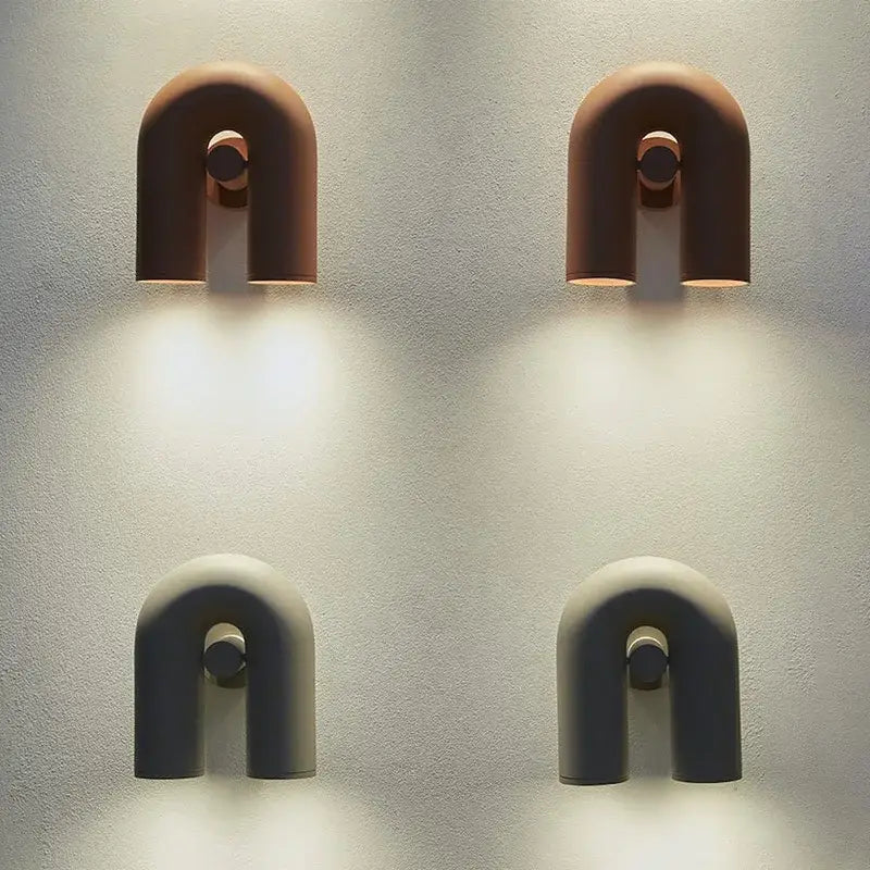 Two minimalist u-shaped cirkus tube wall sconces in terracotta and matte gray ceramic for bedroom reading light