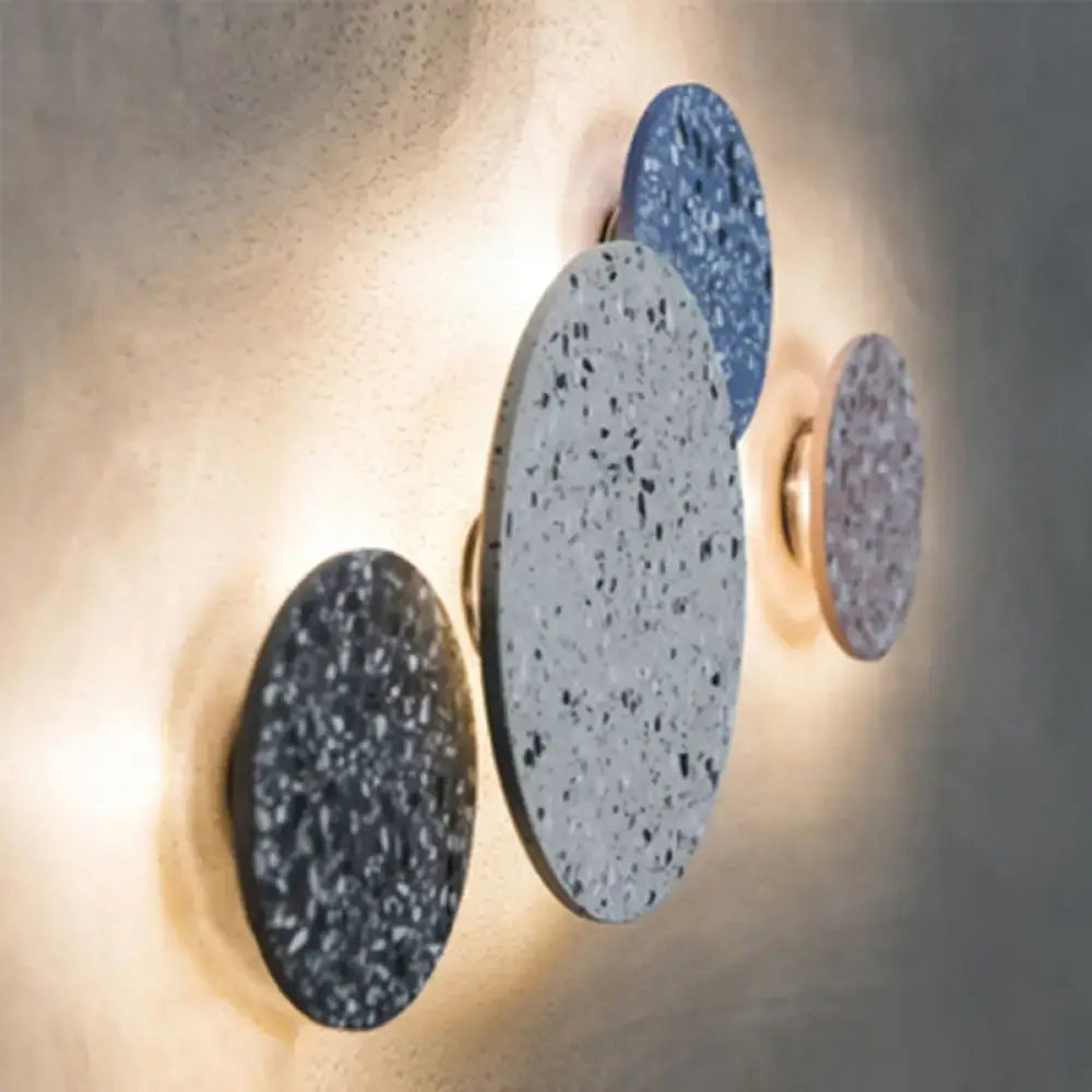 Modern circular led wall sconces with speckled gray blue and purple terrazzo finishes for minimalist bedroom lighting