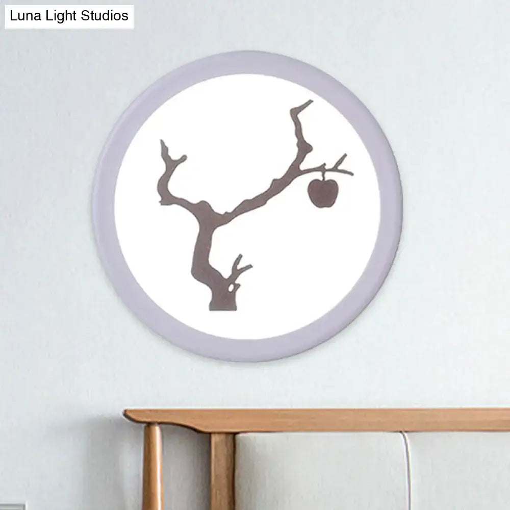 Circular wall lamp with lavender frame and white acrylic center featuring a dark brown apple tree branch silhouette