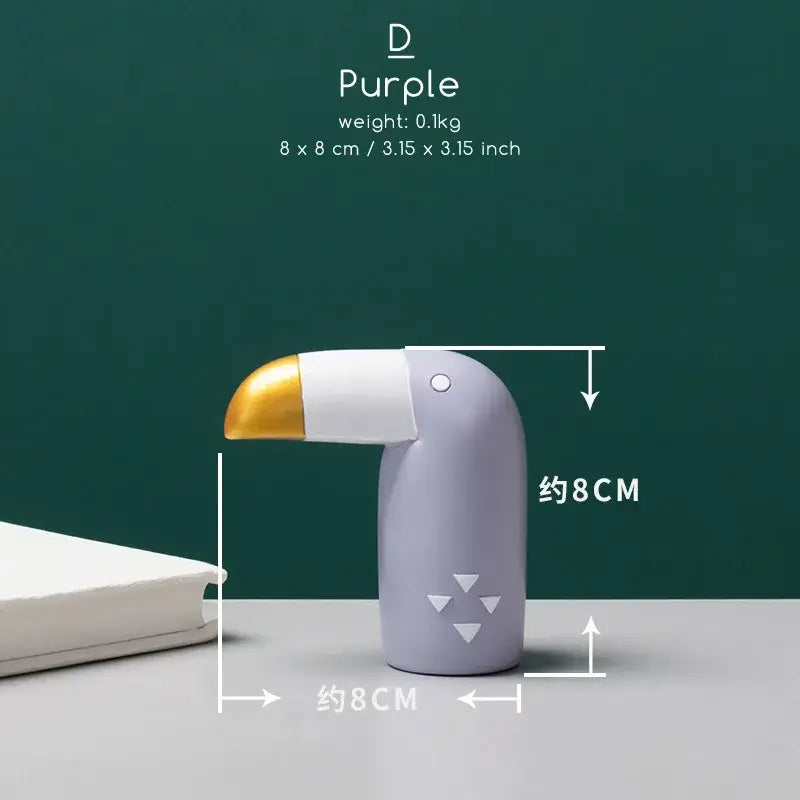 Minimalist turquoise and gold decorbites bird figurine desk organizer shaped like a purple toucan with a gold beak and triangular cutouts