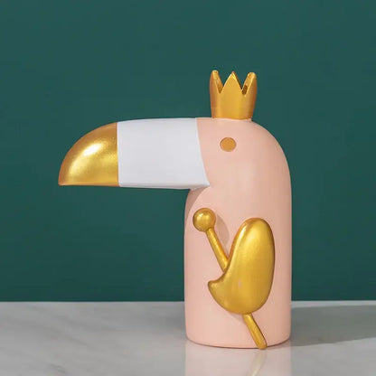 Minimalist turquoise and gold decorbites bird figurine office phone holder featuring pink toucan with gold crown and scepter