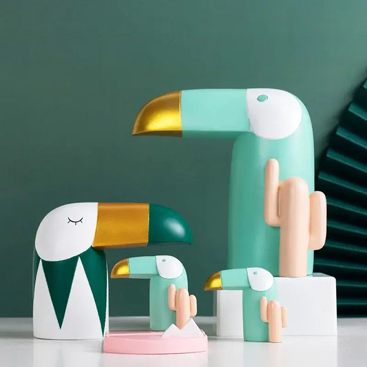 Minimalist turquoise and gold decorbites bird figurine with closed eyes designed as an office phone holder